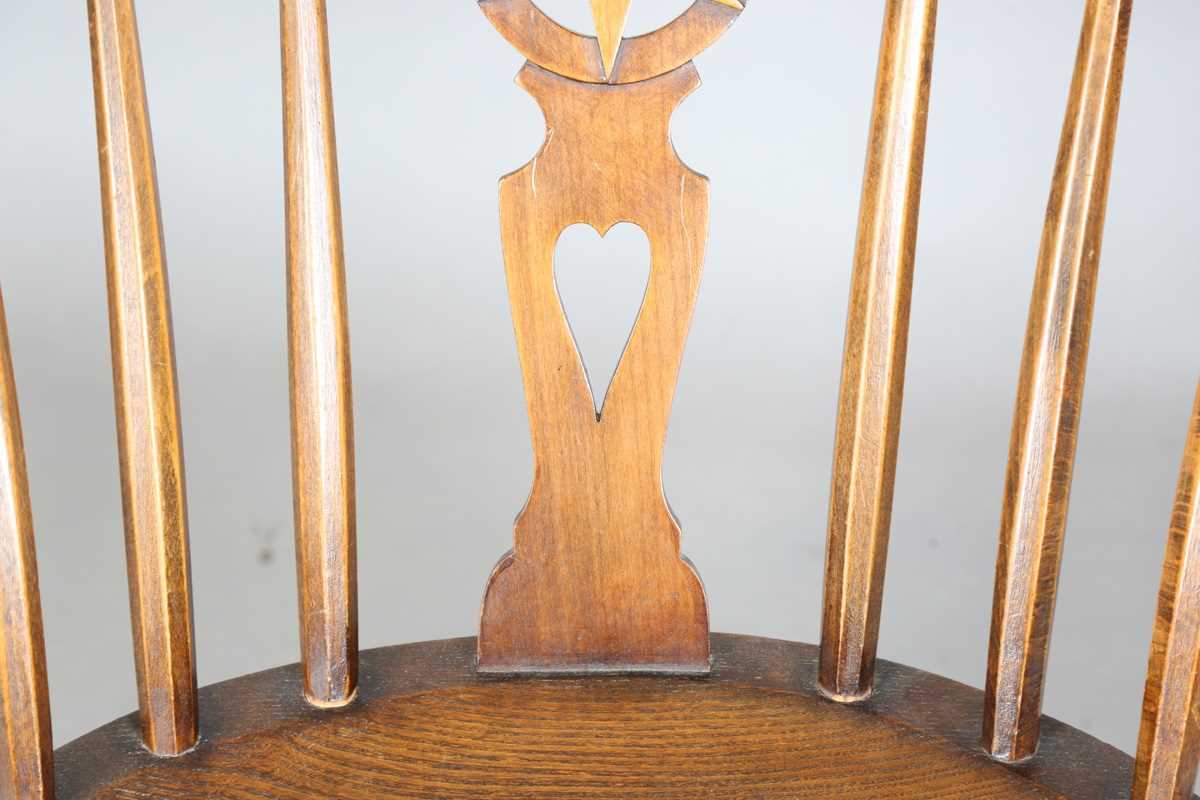 An early 20th century Arts and Crafts ash and elm tub back armchair with a pierced star splat - Image 4 of 9