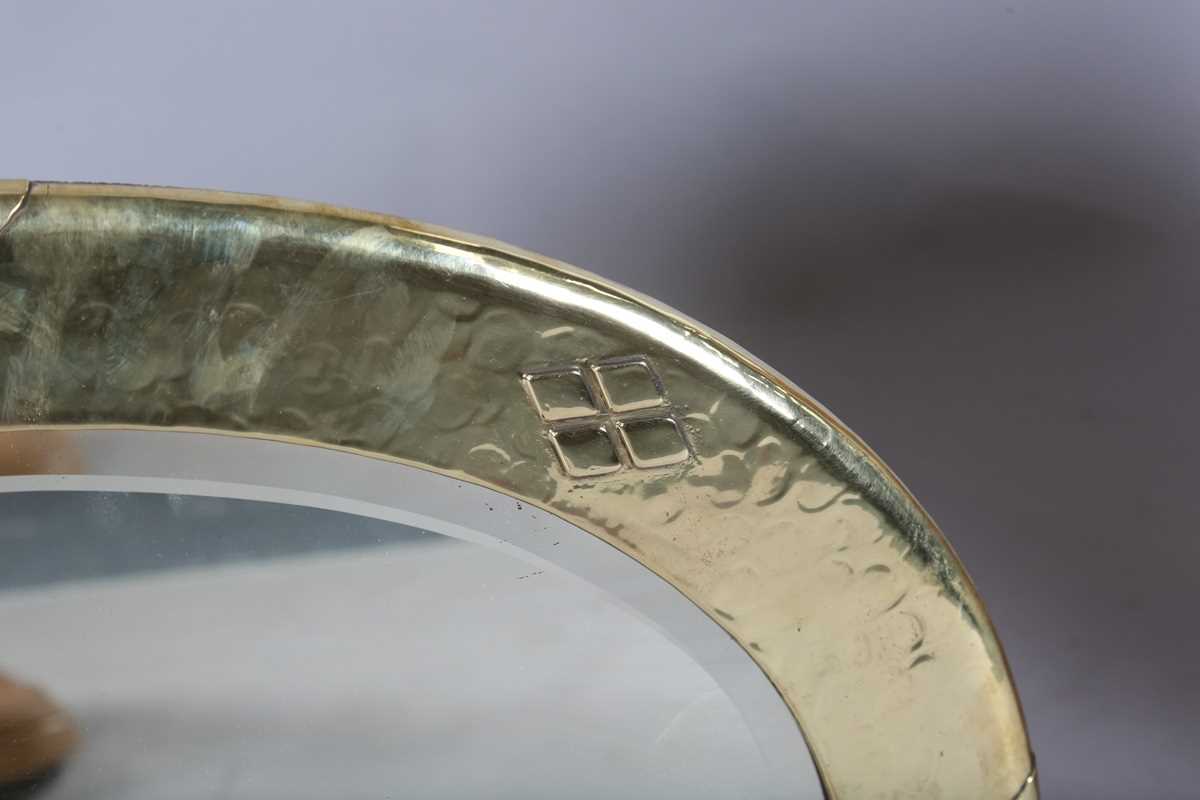 An early 20th century Arts and Crafts brass oval wall mirror with riveted panels and raised - Image 3 of 7