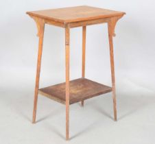 An Edwardian Arts and Crafts oak two-tier occasional table, on tapering block legs, height 70cm,