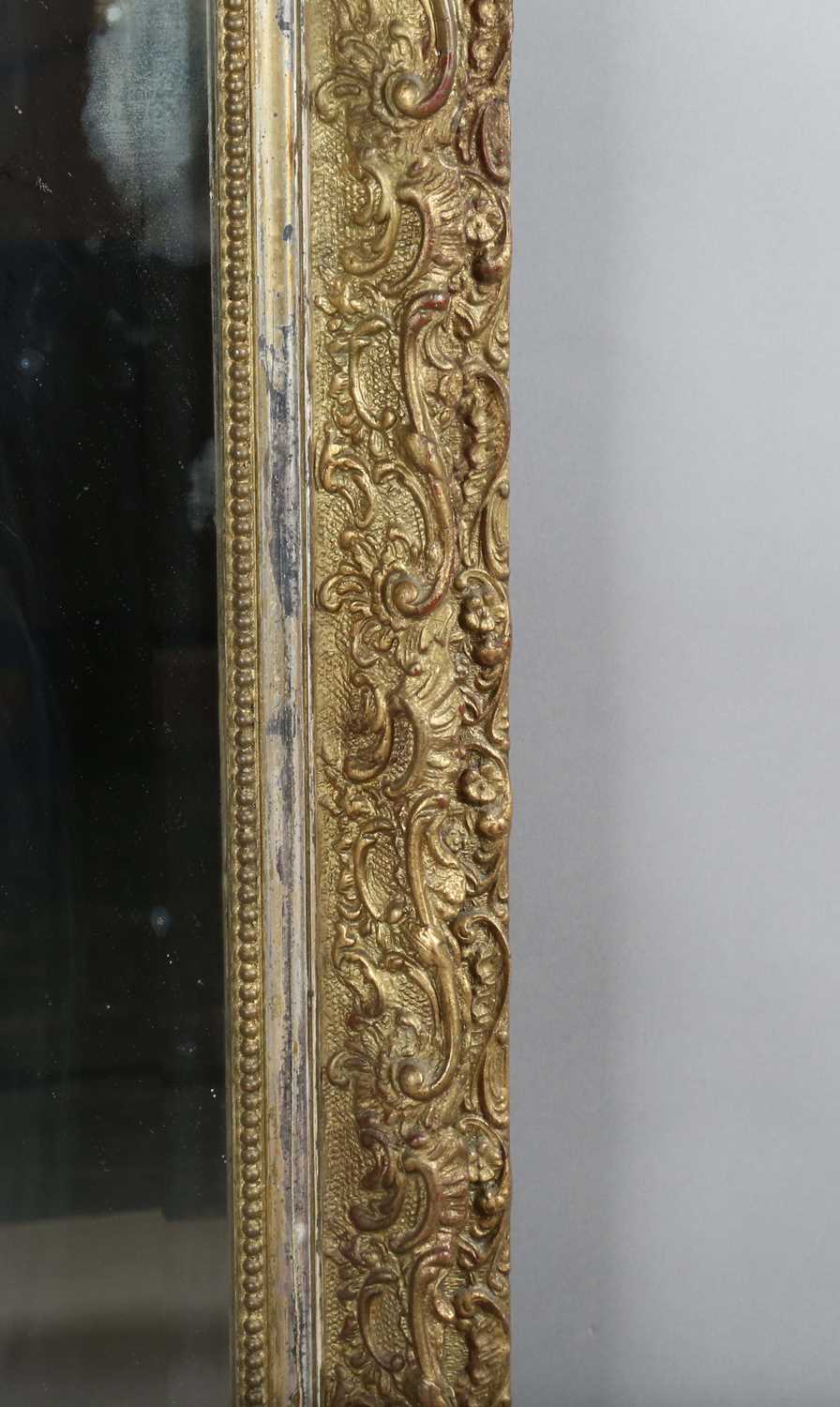 A late 19th century gilt composition arched overmantel mirror with a foliate scroll surmount and - Image 6 of 15