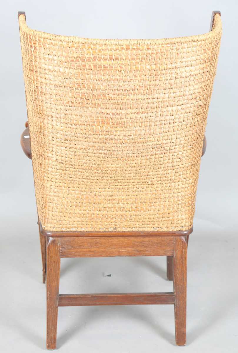 An early 20th century oak framed Orkney armchair, the curved woven straw back and string seat raised - Image 11 of 14