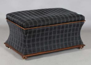 A Victorian mahogany framed rectangular ottoman with hinged lid and concave sides, raised on cup
