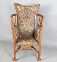 An Edwardian Arts and Crafts mahogany framed armchair, in the manner of G.M. Ellwood and possibly