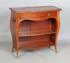 A 20th century Colonial French hardwood open dwarf bookcase of bombé form, fitted with two drawers