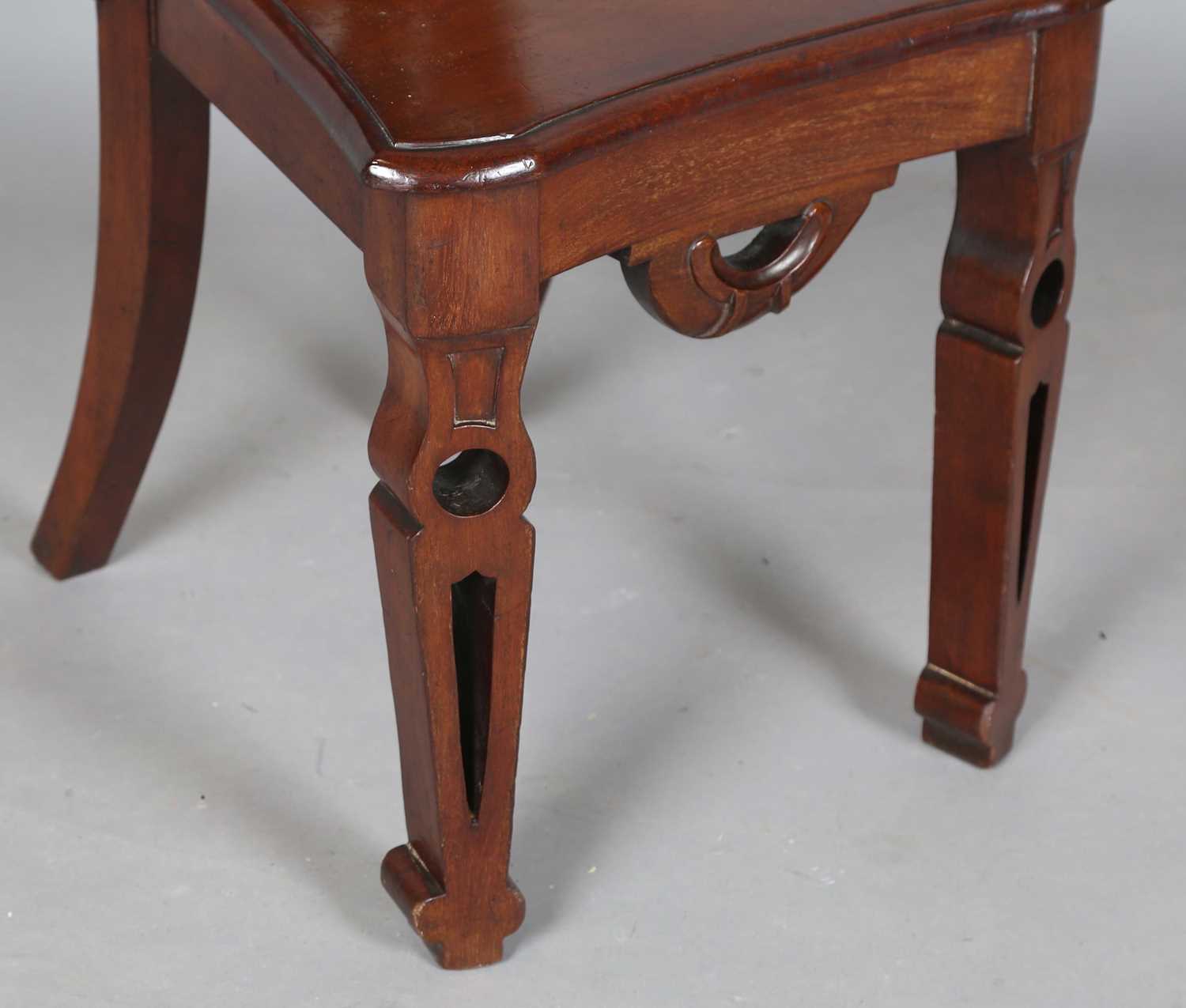 A mid-Victorian mahogany hall chair, the finely carved shield back above a solid seat, raised on - Image 4 of 8