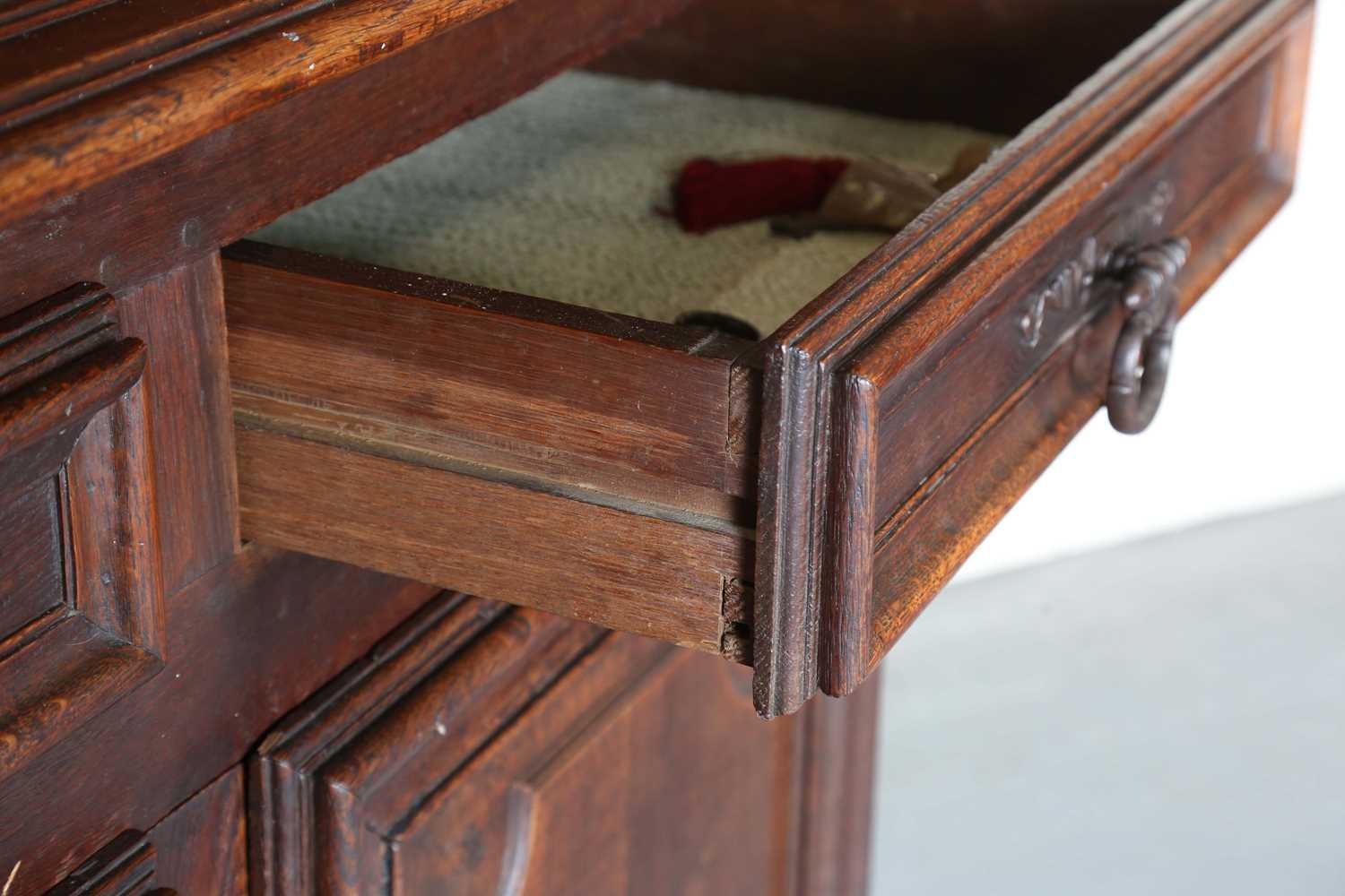 A large 18th century Continental oak cupboard, fitted with four panelled doors and two drawers, - Image 6 of 17