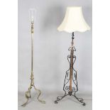 An early 20th century Arts and Crafts brass lamp standard, on splayed tripod legs, height 144cm,