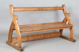 A late Victorian Gothic Revival pine pew with chamfered open end supports, height 91cm, width 164cm,