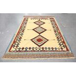 A Ghashghai kelhim carpet, South-west Persia, late 20th century, the sand-coloured field with a