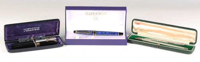 A Waterman blue cased fountain pen, boxed, two Sheaffer fountain pens and a silver propelling pencil