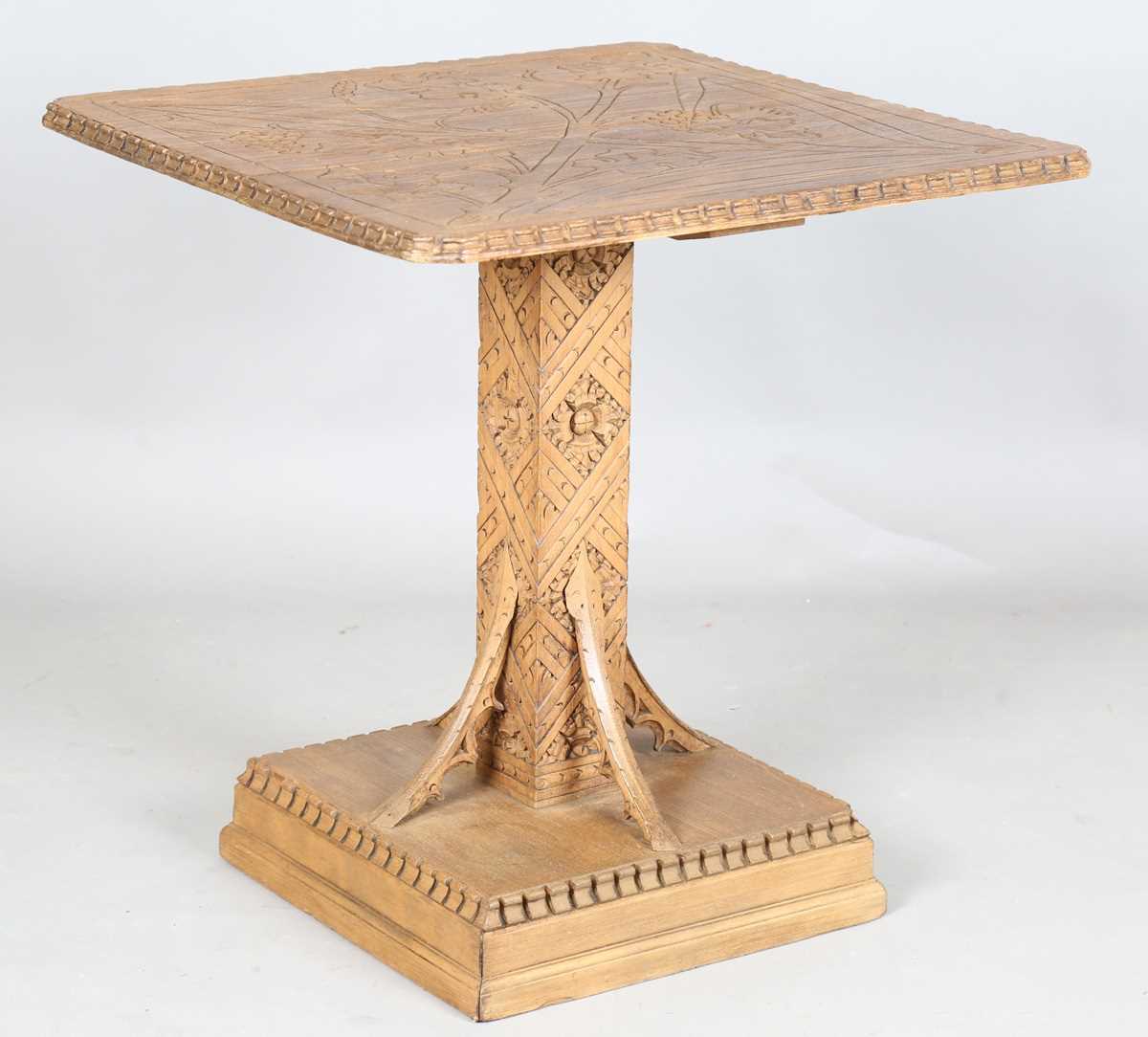 A 20th century Arts and Crafts style carved softwood centre table, the top decorated with wheat