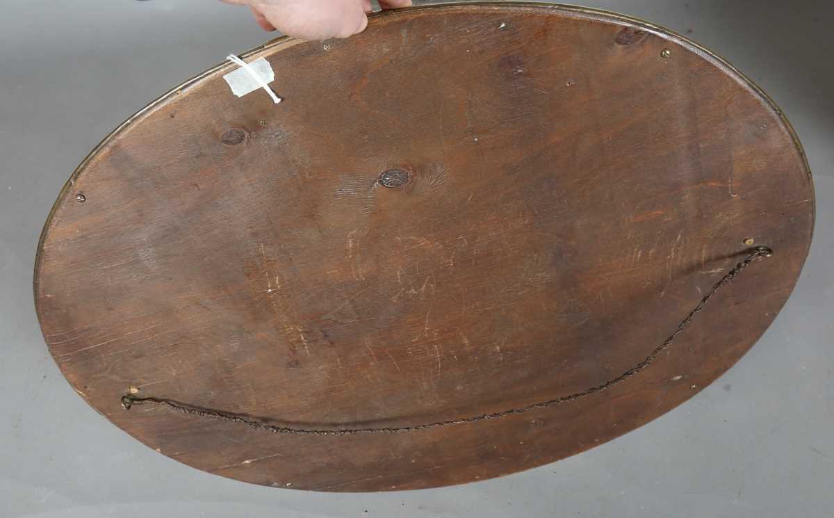 An early 20th century Arts and Crafts brass oval wall mirror with riveted panels and raised - Image 7 of 7