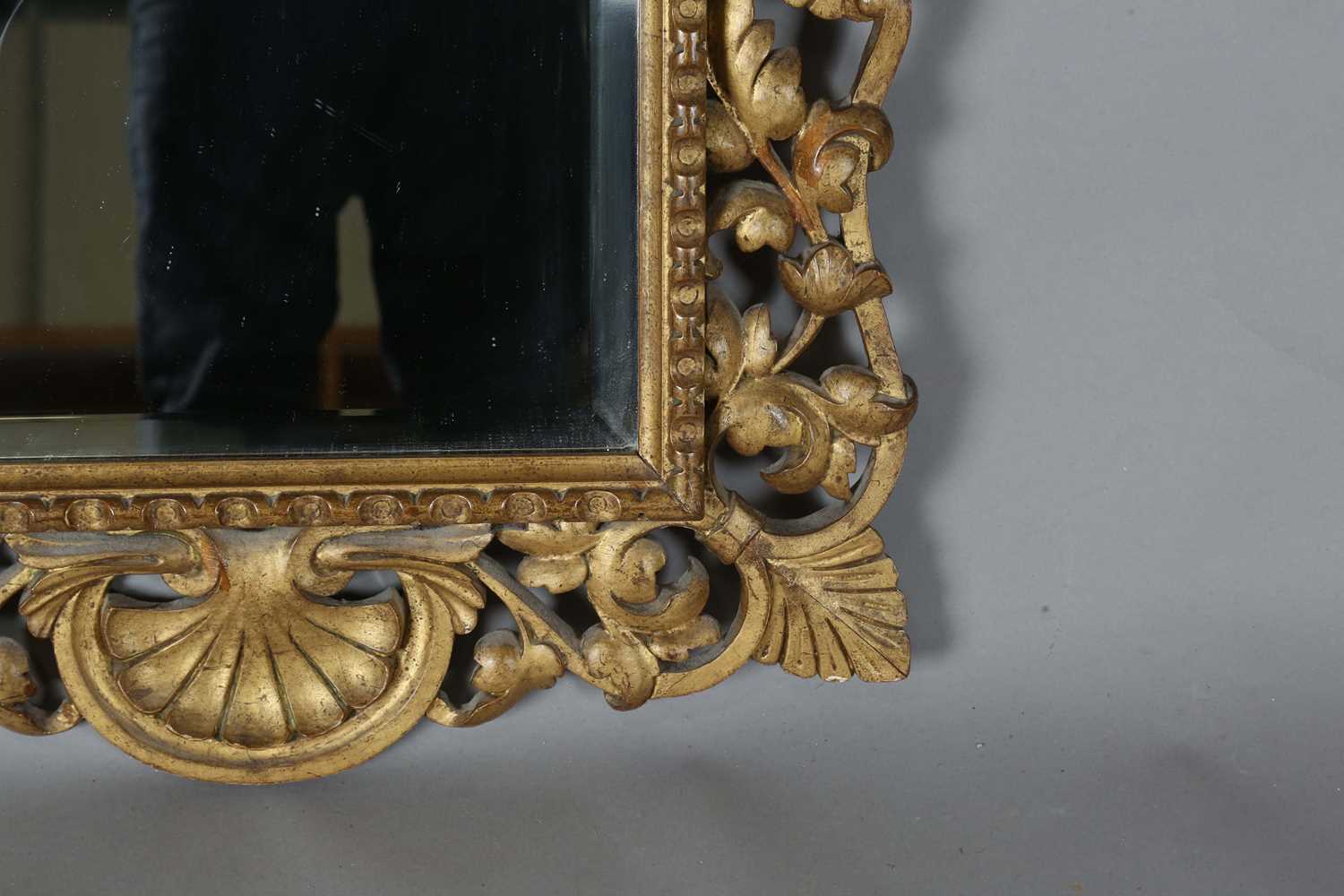 An early 20th century Continental giltwood wall mirror with a carved foliate frame and bevelled - Image 5 of 9