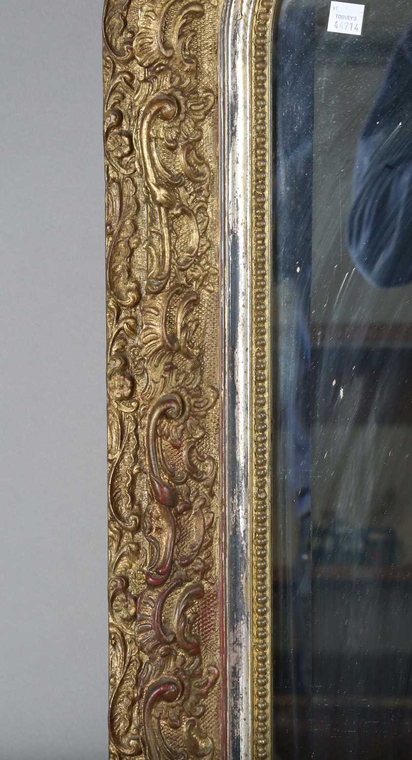 A late 19th century gilt composition arched overmantel mirror with a foliate scroll surmount and - Image 12 of 15