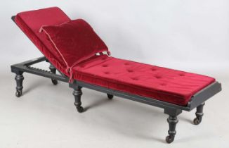 A late Victorian black painted adjustable daybed by 'John Carter, Literary Machine, London', the