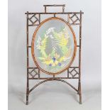 A late Victorian Aesthetic Movement bamboo framed firescreen, the central glazed panel with a