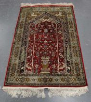 A Kashmir part silk prayer rug, late 20th century, the red mihrab with ascending flower-filled vase,