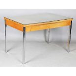 A mid-20th century Stag style teak writing table, in the manner of John and Sylvia Reid, raised on