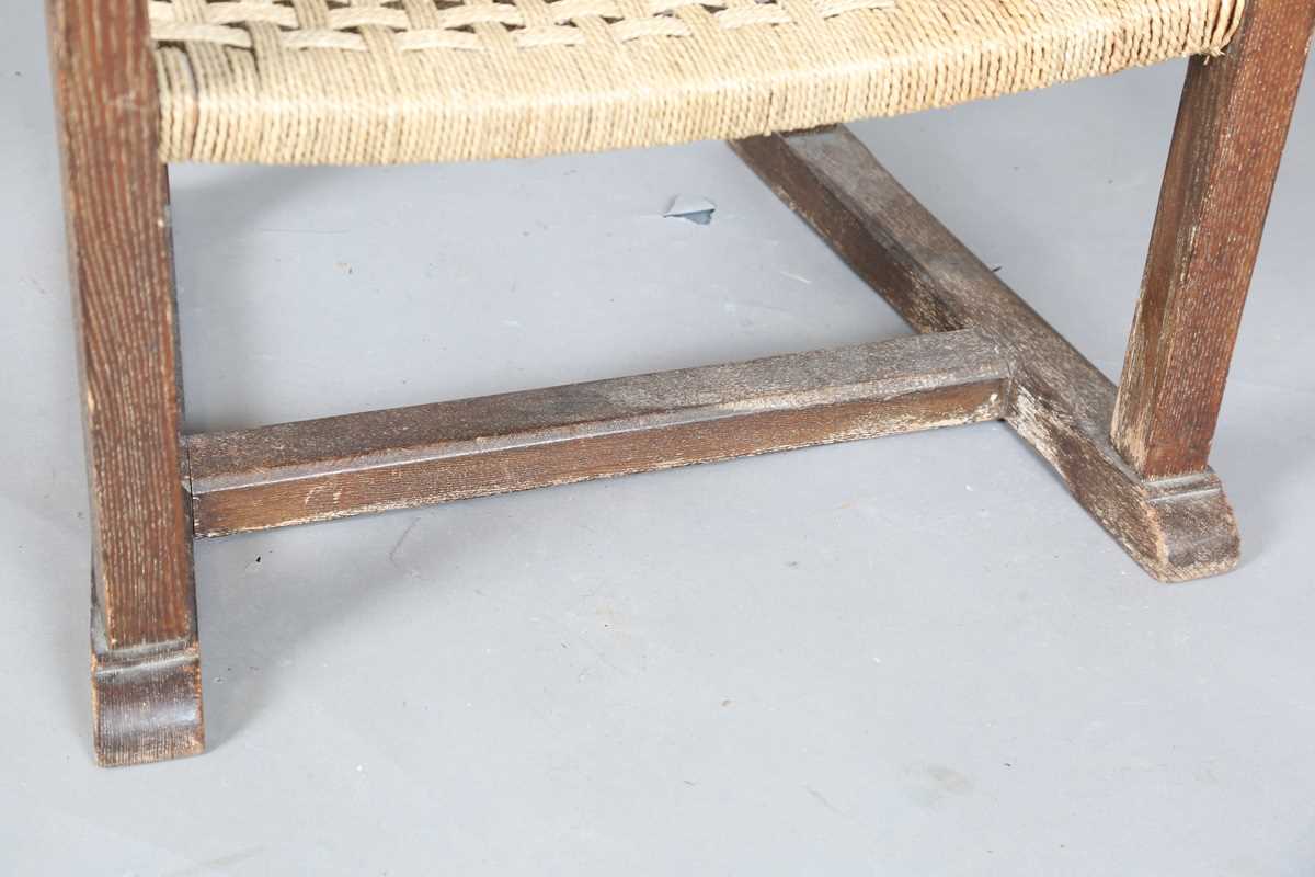 An early 20th century Cotswold School limed oak low elbow chair with woven string seat, height 70cm, - Image 5 of 10