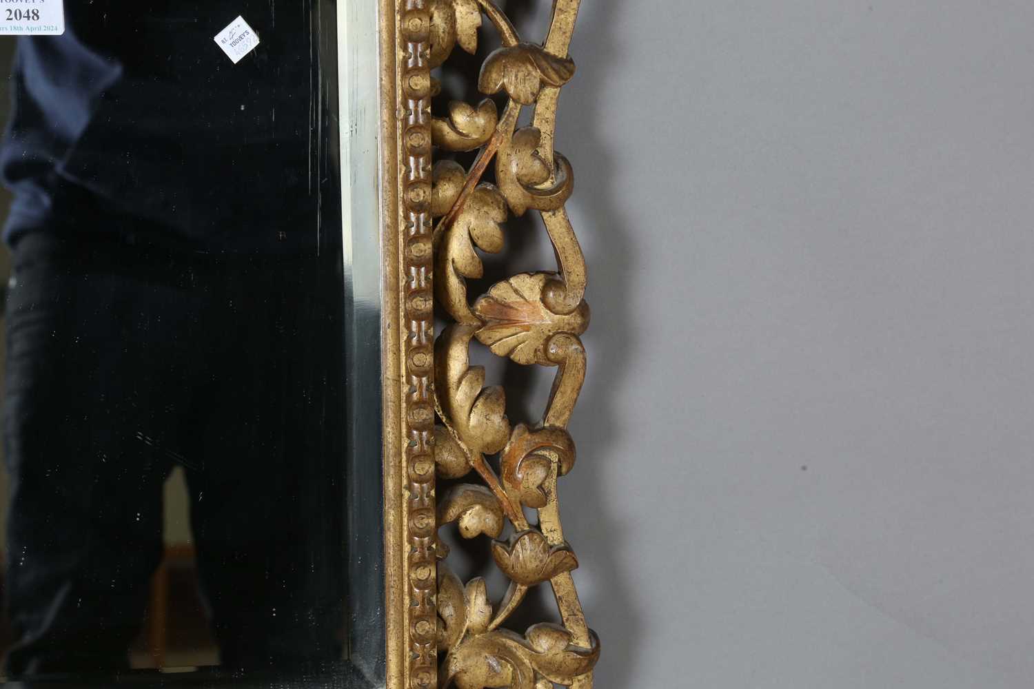 An early 20th century Continental giltwood wall mirror with a carved foliate frame and bevelled - Image 4 of 9