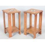 A pair of early 20th century Arts and Crafts walnut two-tier occasional tables, both stamped '