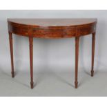 A George III mahogany fold-over demi-lune tea table with tulipwood and satinwood crossbanding within