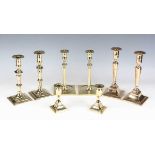A pair of 18th century polished brass ejector candlesticks with square bases, height 22.5cm,