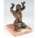 An early 20th century Continental brown patinated cast bronze figure of a kneeling nude male, raised