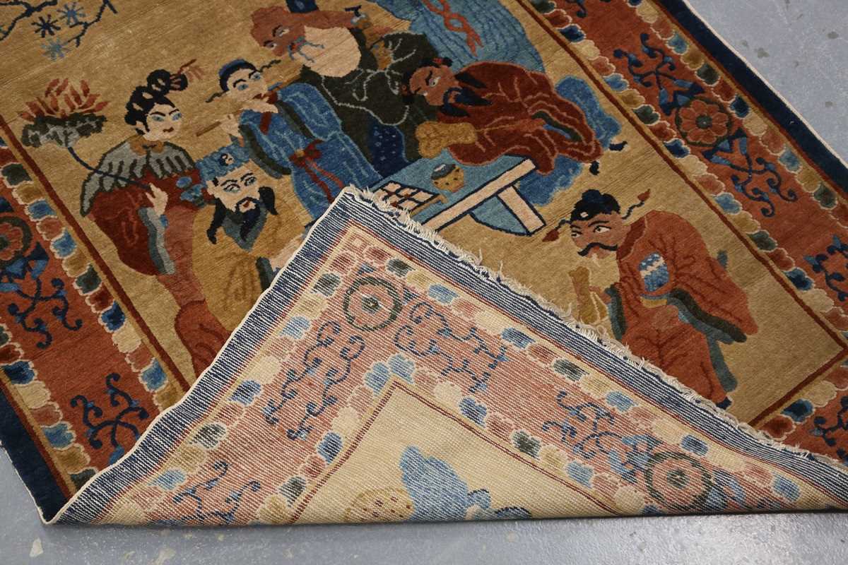 A Chinese rug, early 20th century, the sand-coloured field with standing and seated figures around a - Image 7 of 7
