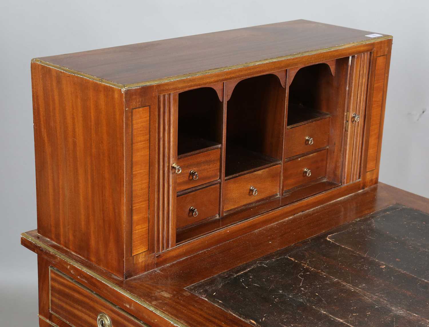 An early 20th century French mahogany and brass mounted bureau plat with raised tambour compartment, - Image 4 of 19