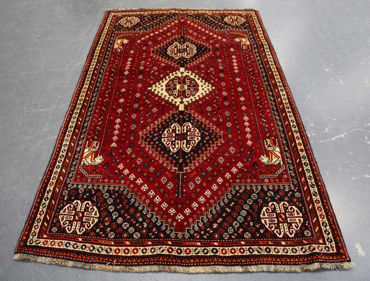 A Ghashghai rug, South-west Persia, late 20th century, the red field with three linked medallions,