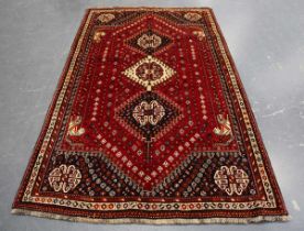 A Ghashghai rug, South-west Persia, late 20th century, the red field with three linked medallions,