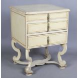 An early 20th century French cream painted bedside chest of three drawers, on scroll legs, height