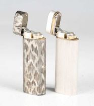 A Cartier pocket lighter with textured case, length 7cm, and another Cartier lighter with machined