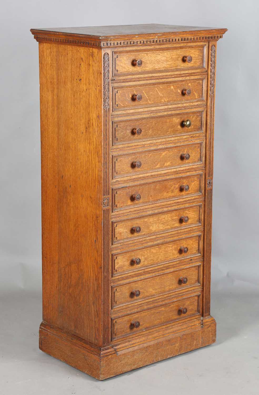 A fine Edwardian oak Wellington chest of nine drawers, probably by Gillows or Holland & Sons, the
