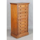A fine Edwardian oak Wellington chest of nine drawers, probably by Gillows or Holland & Sons, the