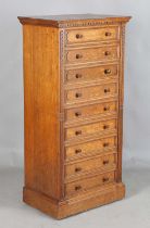 A fine Edwardian oak Wellington chest of nine drawers, probably by Gillows or Holland & Sons, the