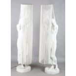 A pair of modern moulded composite floor-standing figural lamps, each in the form of a standing