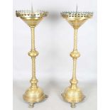 A pair of late 19th century Gothic style brass ecclesiastical pricket candle stands, each circular