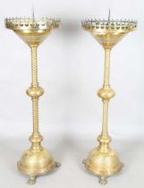 A pair of late 19th century Gothic style brass ecclesiastical pricket candle stands, each circular