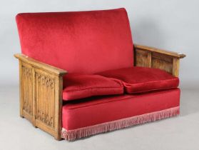 An early 20th century oak-sided two-seat settee, the sides carved with linenfold panels, height