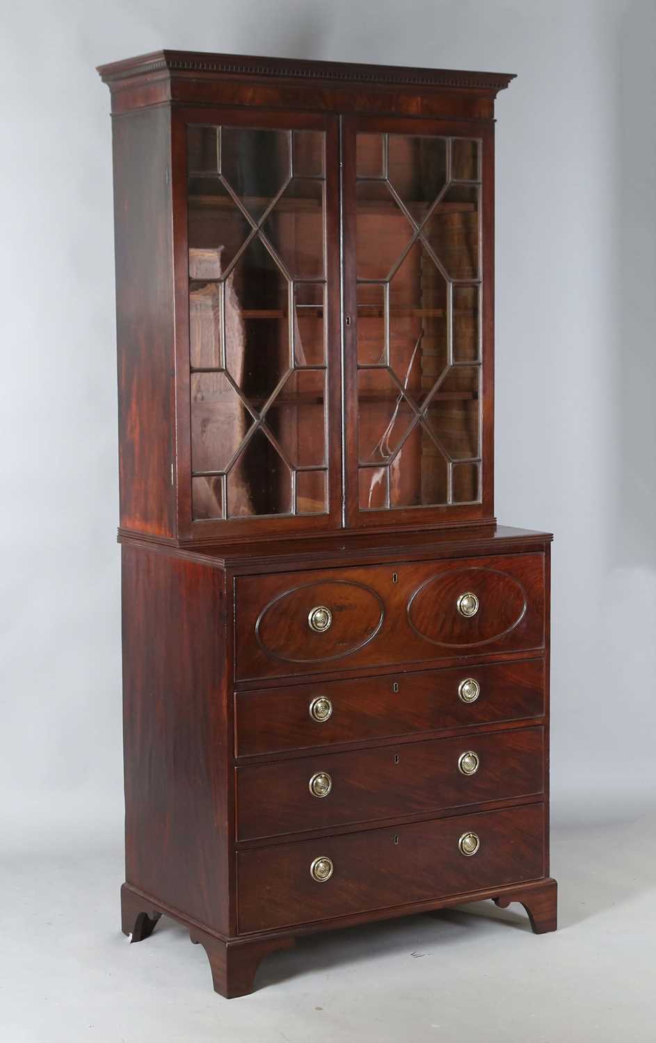 A good George III figured mahogany narrow secrétaire bookcase cabinet, the glazed top above a