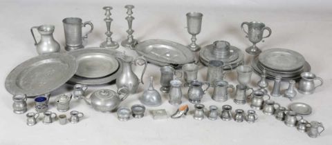 A large collection of mainly 19th century pewter, including three large chargers, various plates,