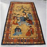 A Chinese rug, early 20th century, the sand-coloured field with standing and seated figures around a