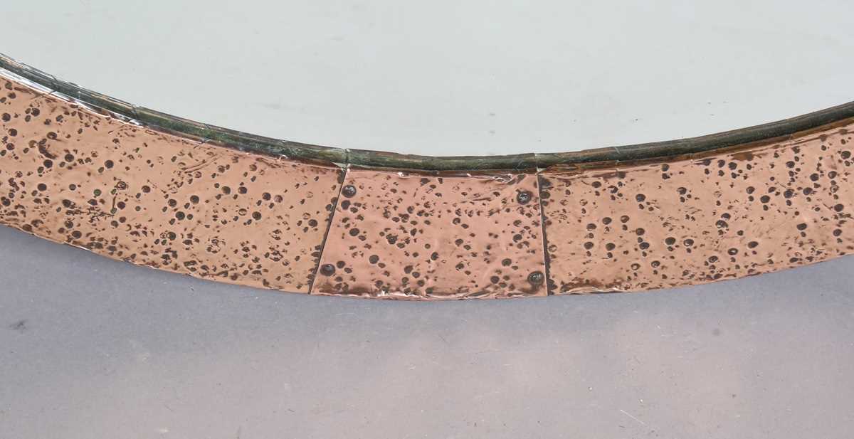 An early 20th century Arts and Crafts hammered copper oval wall mirror with riveted panels and - Image 4 of 6