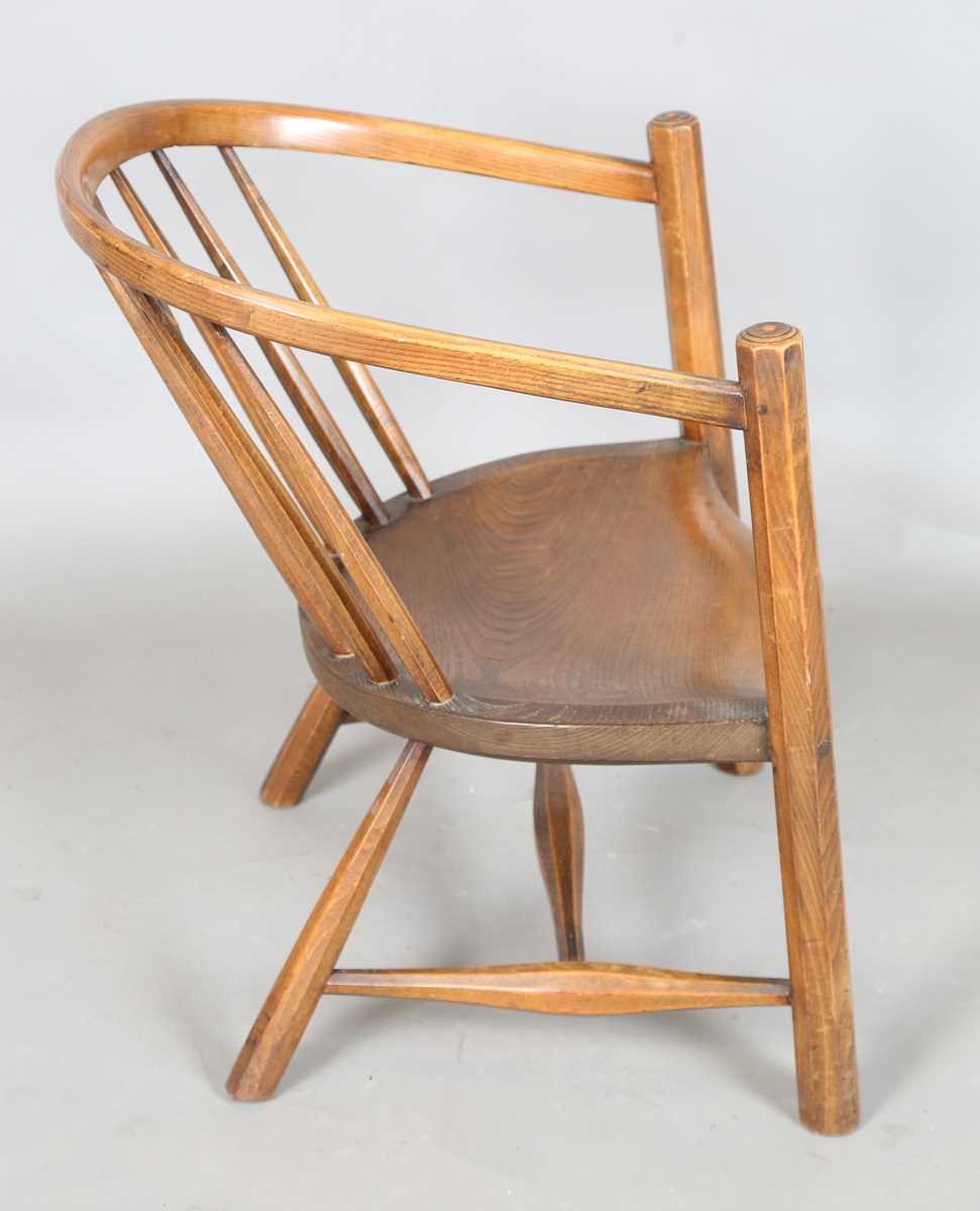 An early 20th century Arts and Crafts ash and elm tub back armchair with a pierced star splat - Image 6 of 9