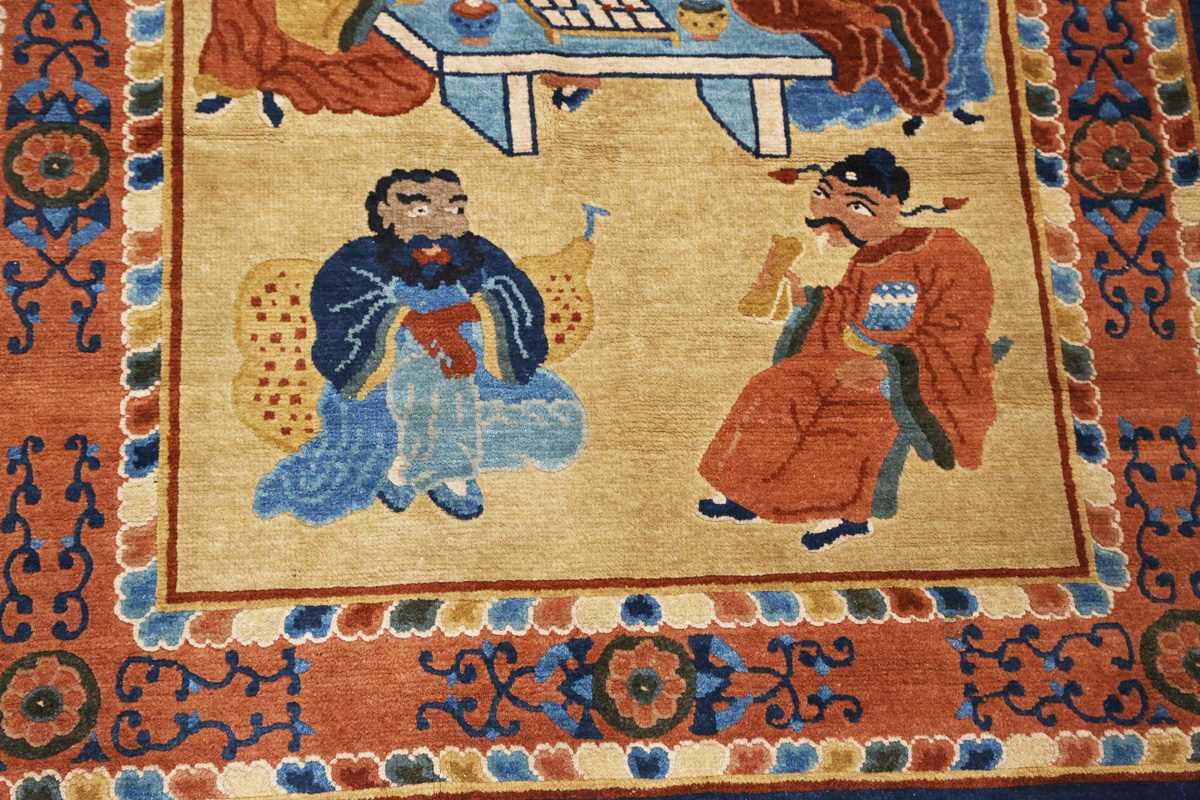 A Chinese rug, early 20th century, the sand-coloured field with standing and seated figures around a - Image 5 of 7