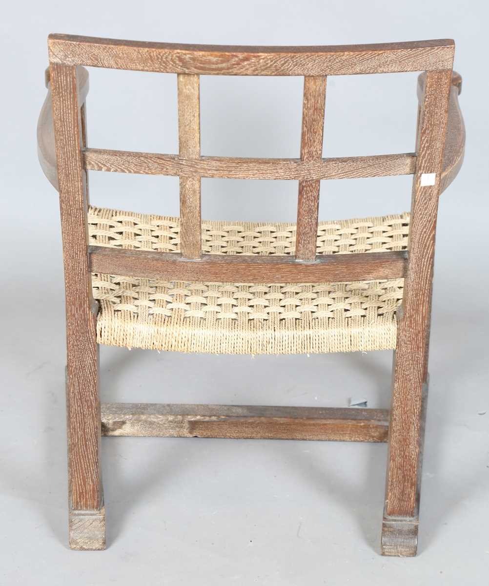 An early 20th century Cotswold School limed oak low elbow chair with woven string seat, height 70cm, - Image 9 of 10