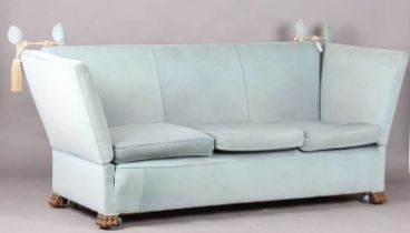 An early 20th century Knole settee, upholstered in pale blue/green velour, on carved hairy claw