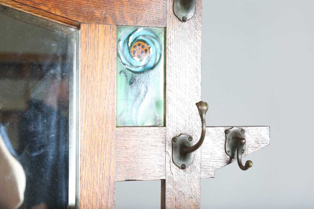An Edwardian Arts and Crafts Glasgow School oak hallstand, the mirrored back inset with glazed - Image 6 of 13